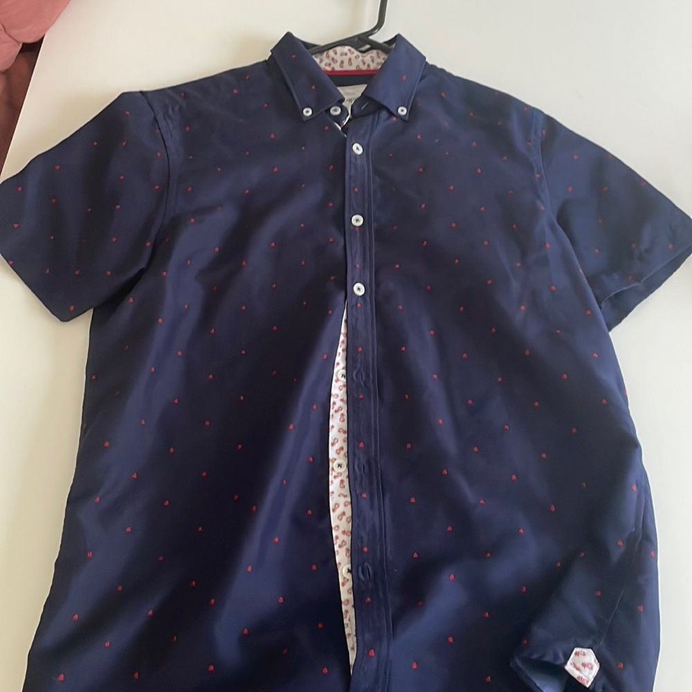 Dad shirt, little red sailboats and pineapples down the center inside buttons